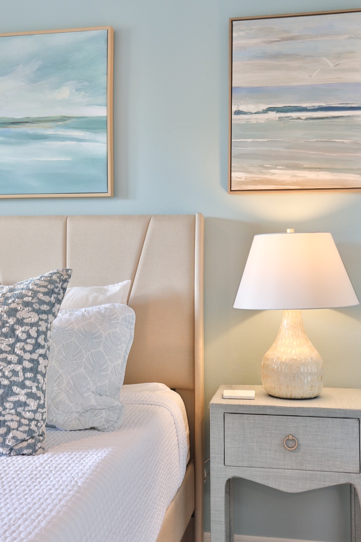 Drift off in your serene coastal bedroom, where ocean artwork and soft lighting create the perfect seaside sanctuary.