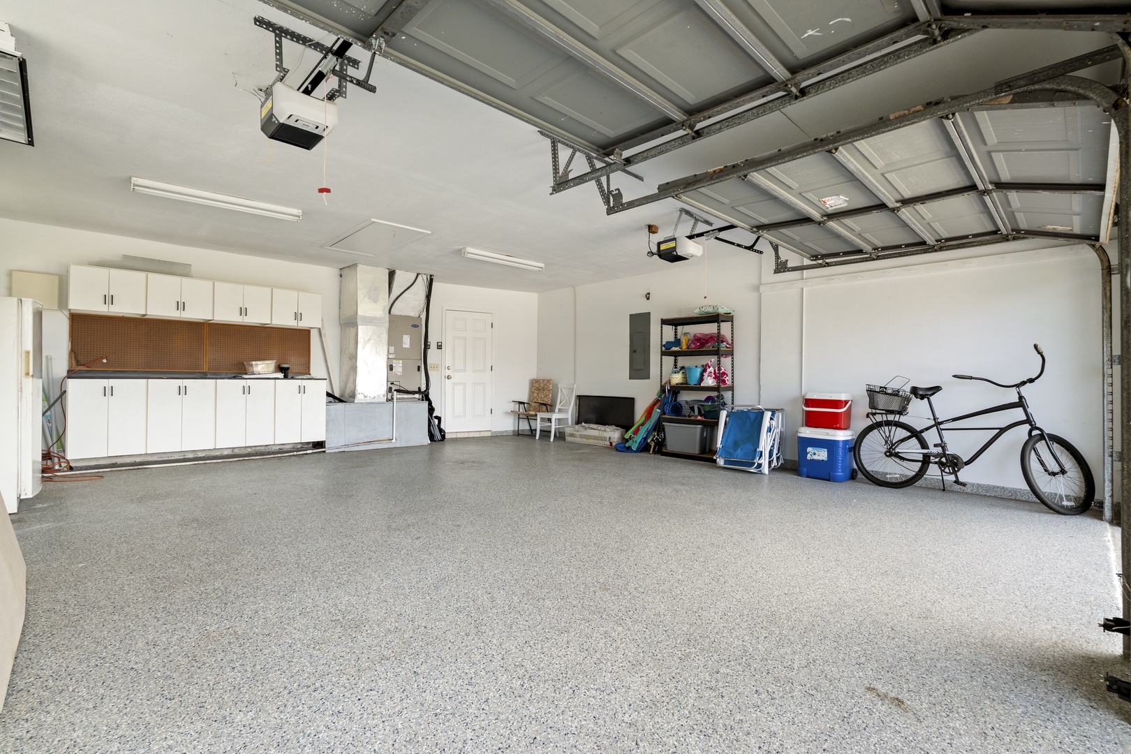 The property features a clean, spacious garage with built-in storage cabinets and plenty of room for your vehicle and gear. This well-organized space provides convenient, secure parking during your stay.