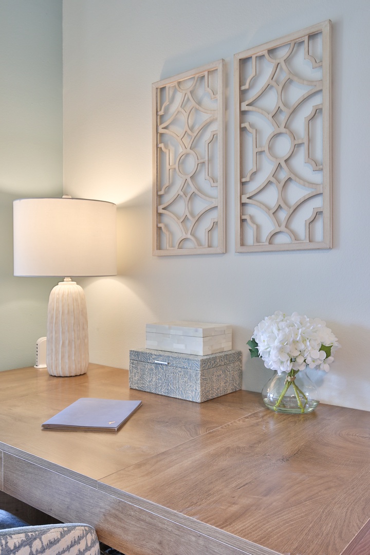Your elegant workspace features warm lighting and fresh florals, creating the perfect spot for peaceful productivity or quiet moments with a book.