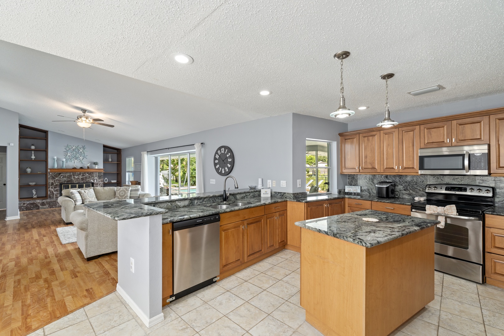 Your gourmet kitchen awaits with gleaming granite counters, stainless steel appliances, and an open flow into the bright living area—perfect for cooking and gathering.