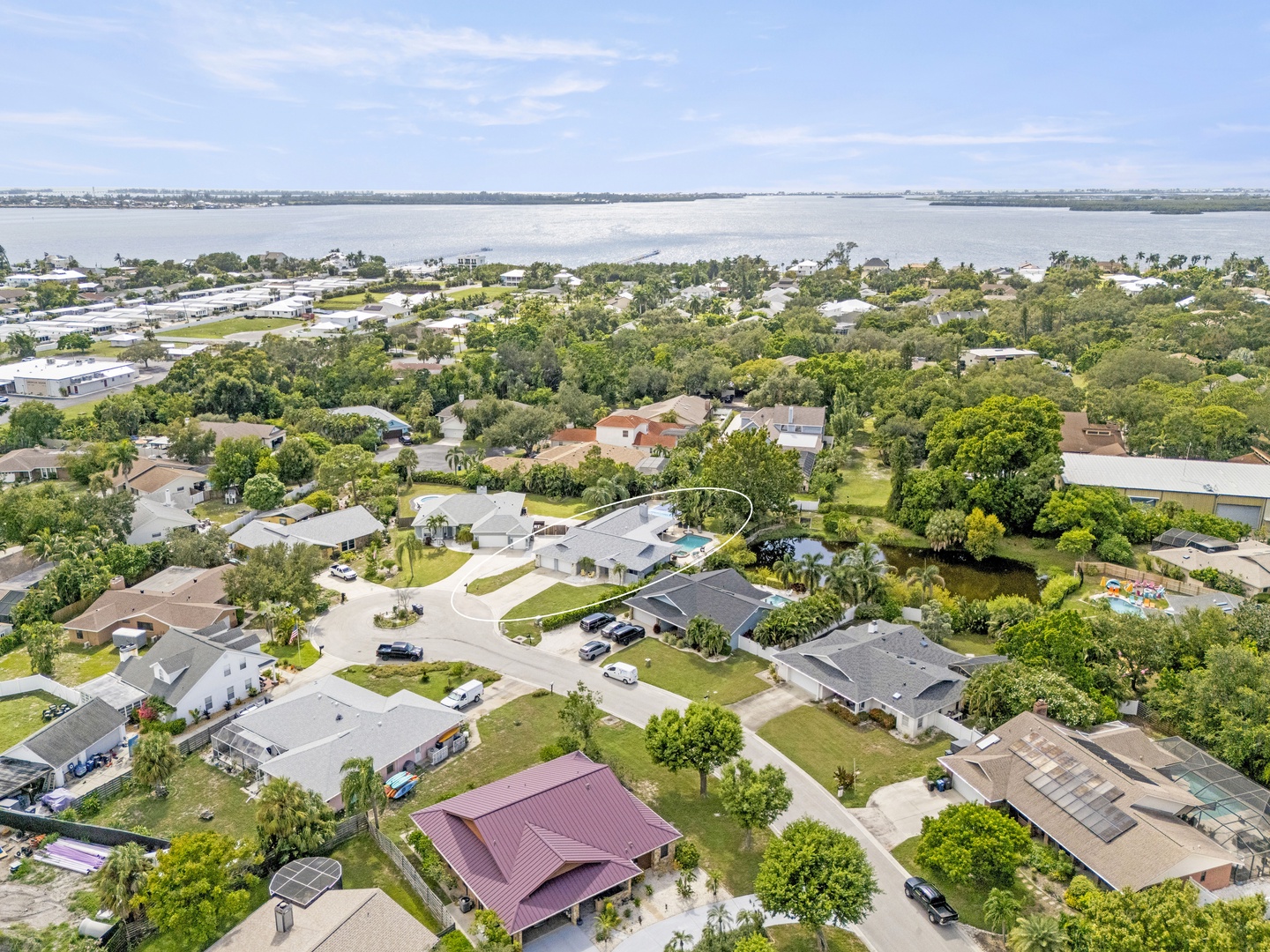 This waterfront neighborhood features a peaceful residential setting with mature trees, spacious yards, and serene water views stretching across the horizon.
