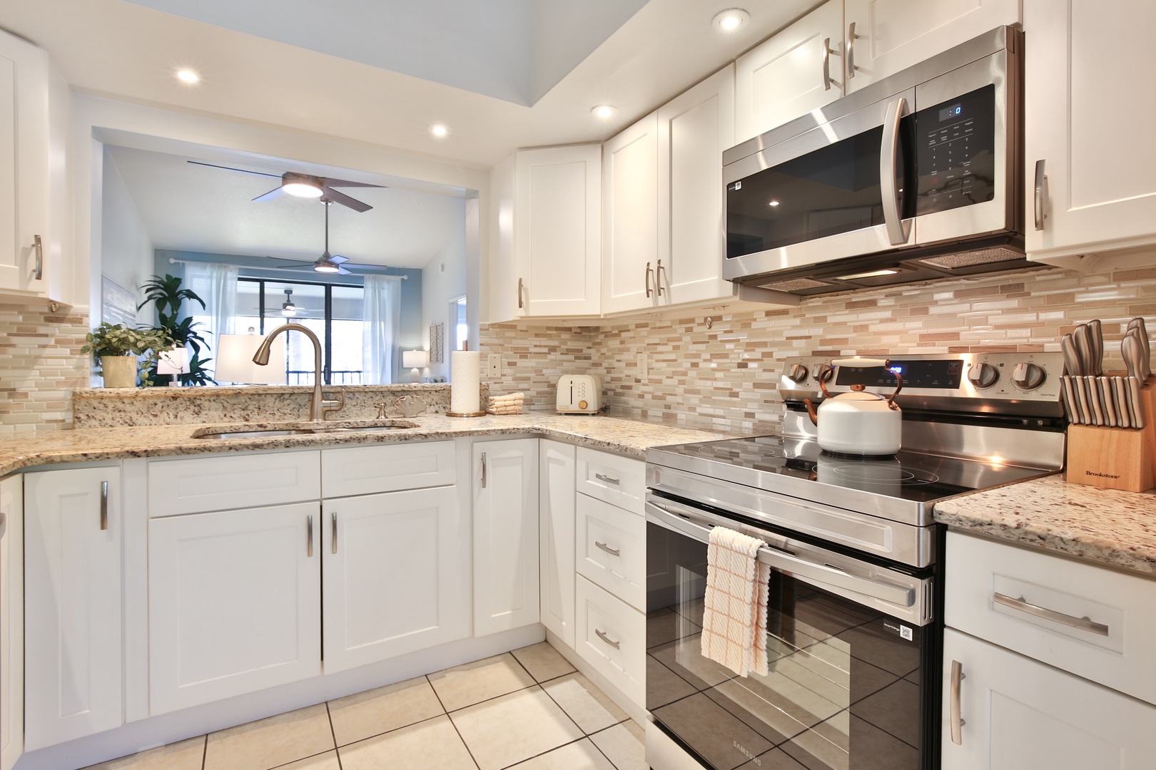 Your modern kitchen features granite counters, stainless appliances, and a stylish tile backsplash—perfect for preparing meals during your stay.
