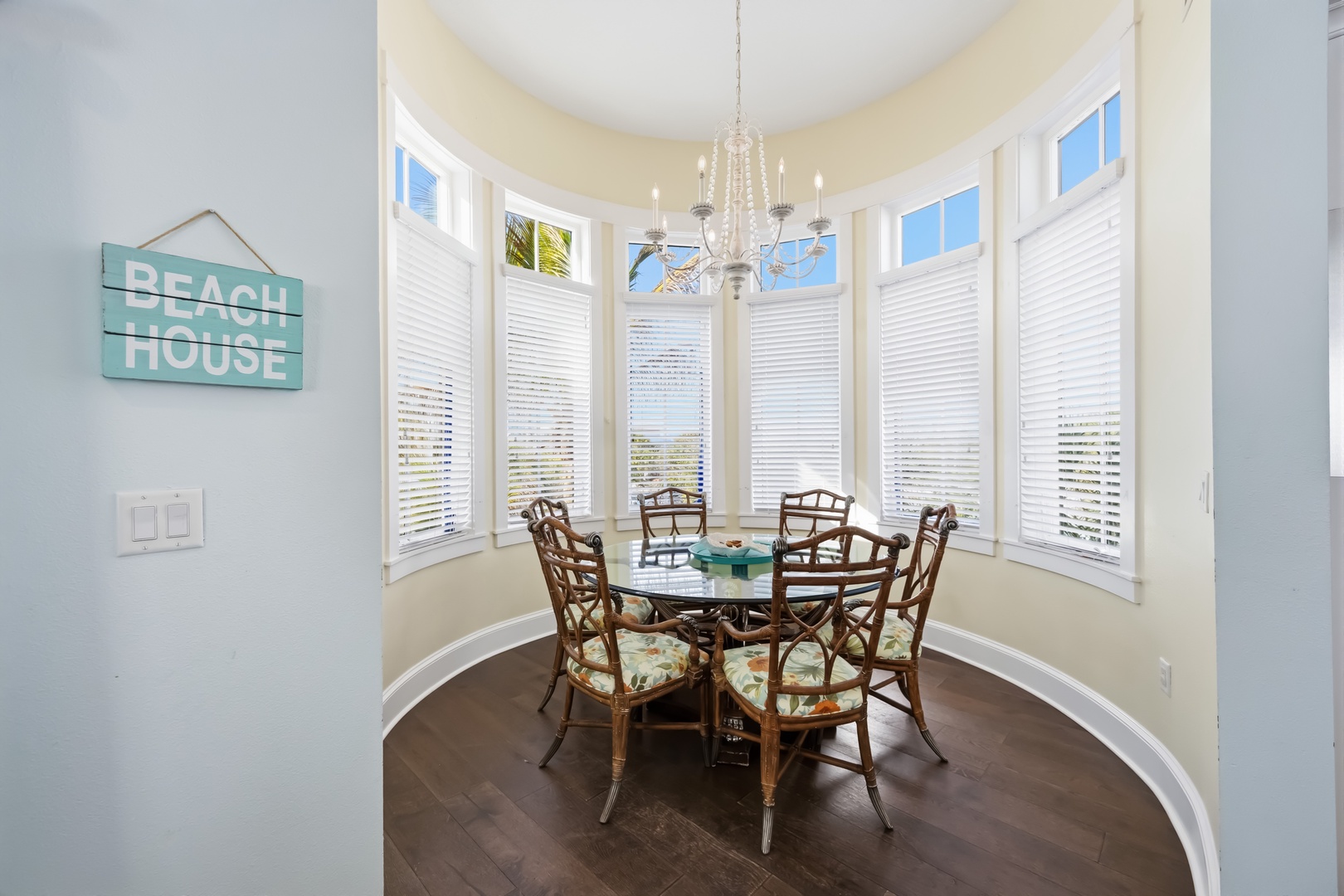 Gather around this elegant breakfast nook where natural light streams through floor-to-ceiling windows, creating the perfect spot for your morning coffee and meal planning.