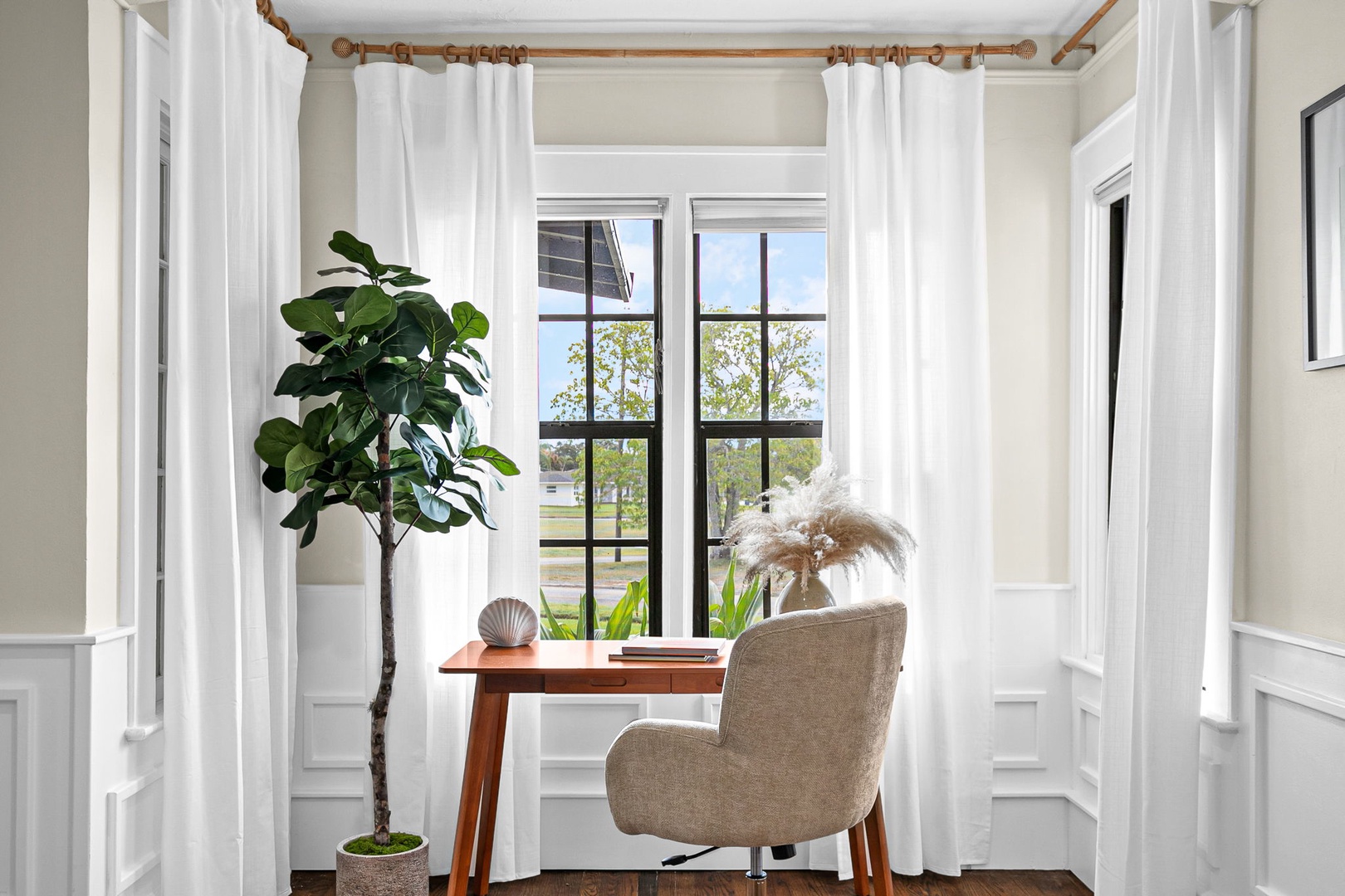 Settle into your private workspace where natural light streams through large windows, creating the perfect spot for morning coffee or productive moments.