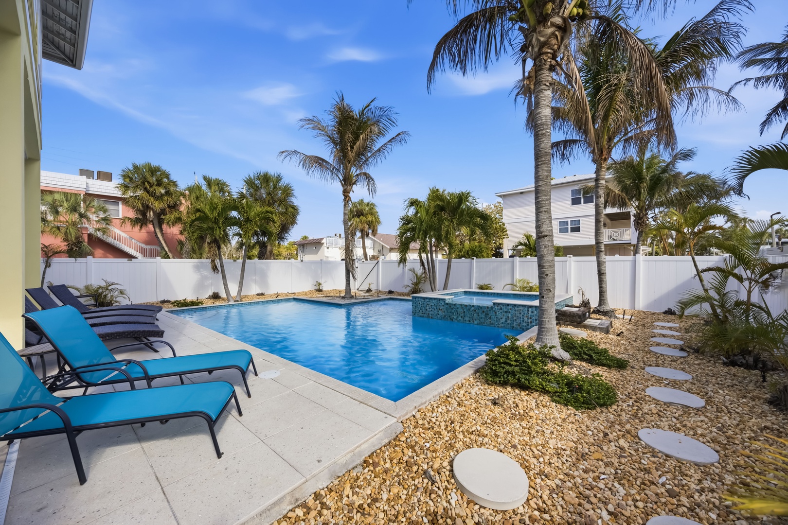 Dive into your private pool oasis surrounded by swaying palms and tropical landscaping, perfect for soaking up the Florida sunshine.