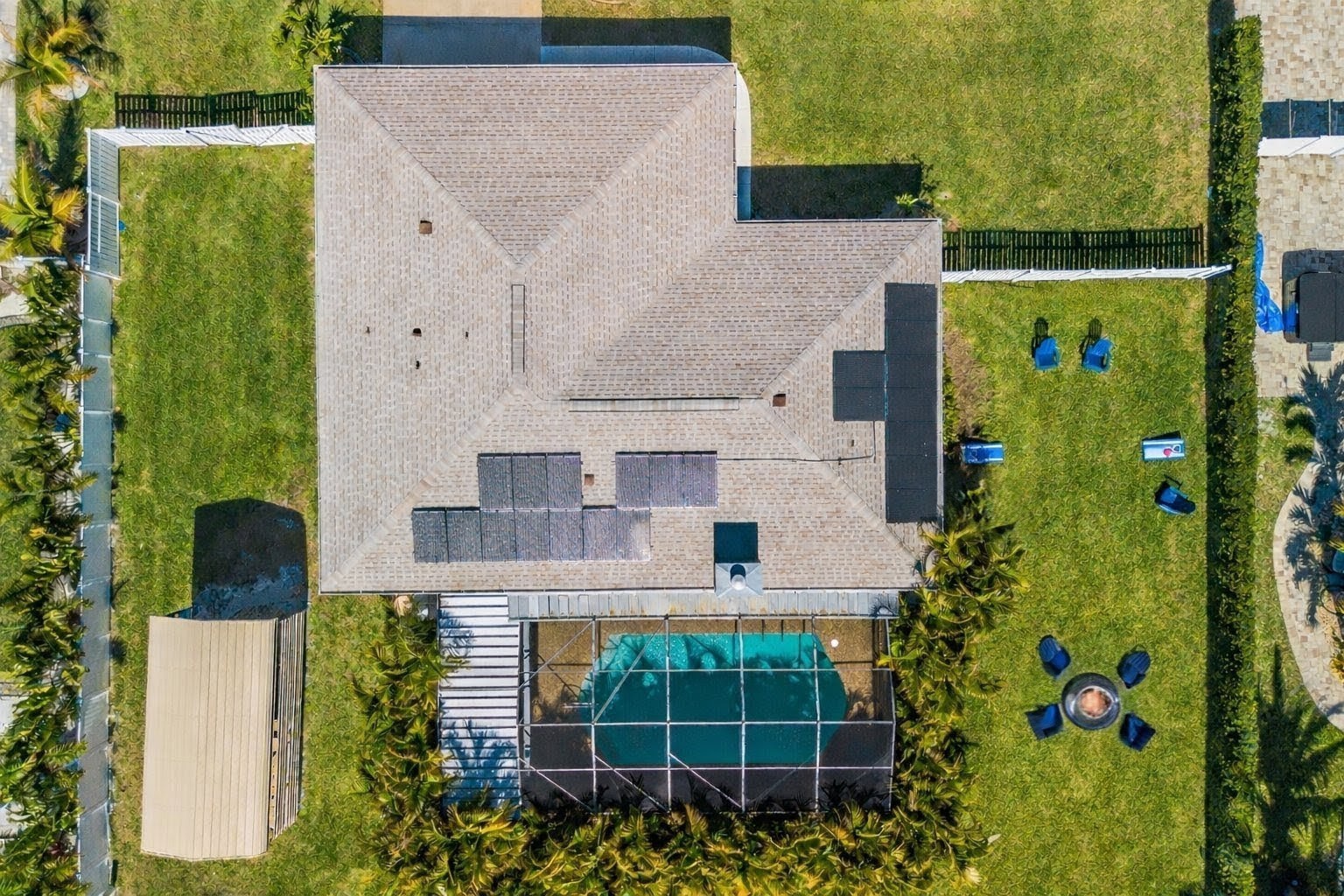 Aerial view showcasing this vacation property's impressive layout with sparkling pool, spacious grounds, and well-designed outdoor living areas perfect for groups.