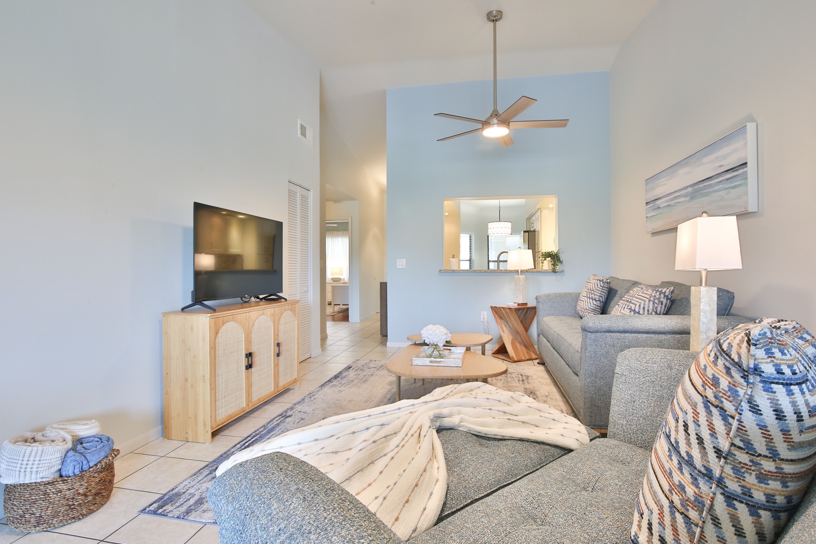 Sink into the plush sectional and enjoy movie nights in your airy living space, complete with coastal touches and open kitchen views.