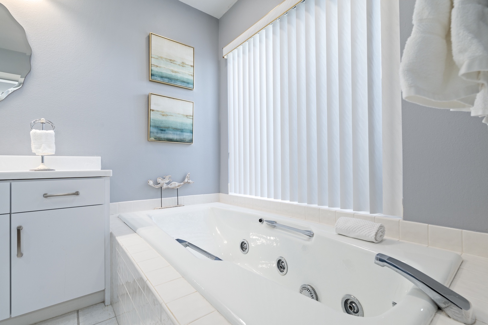 Sink into the soothing jets of your private jetted tub, where soft coastal hues and plush towels create your perfect escape after a day of adventure.