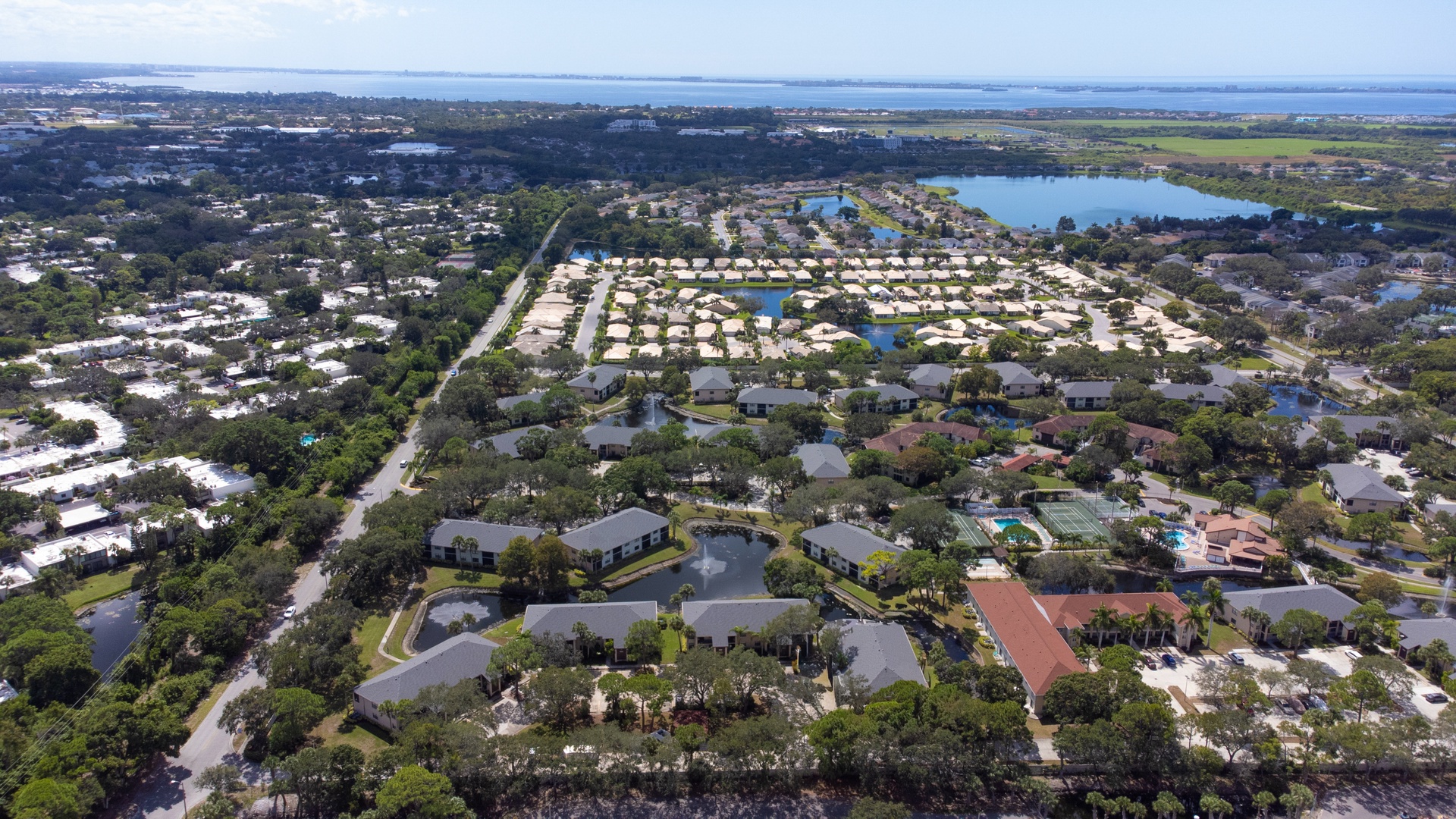Stunning aerial view reveals this waterfront community nestled among lakes and lush landscapes, showcasing the pristine natural setting.