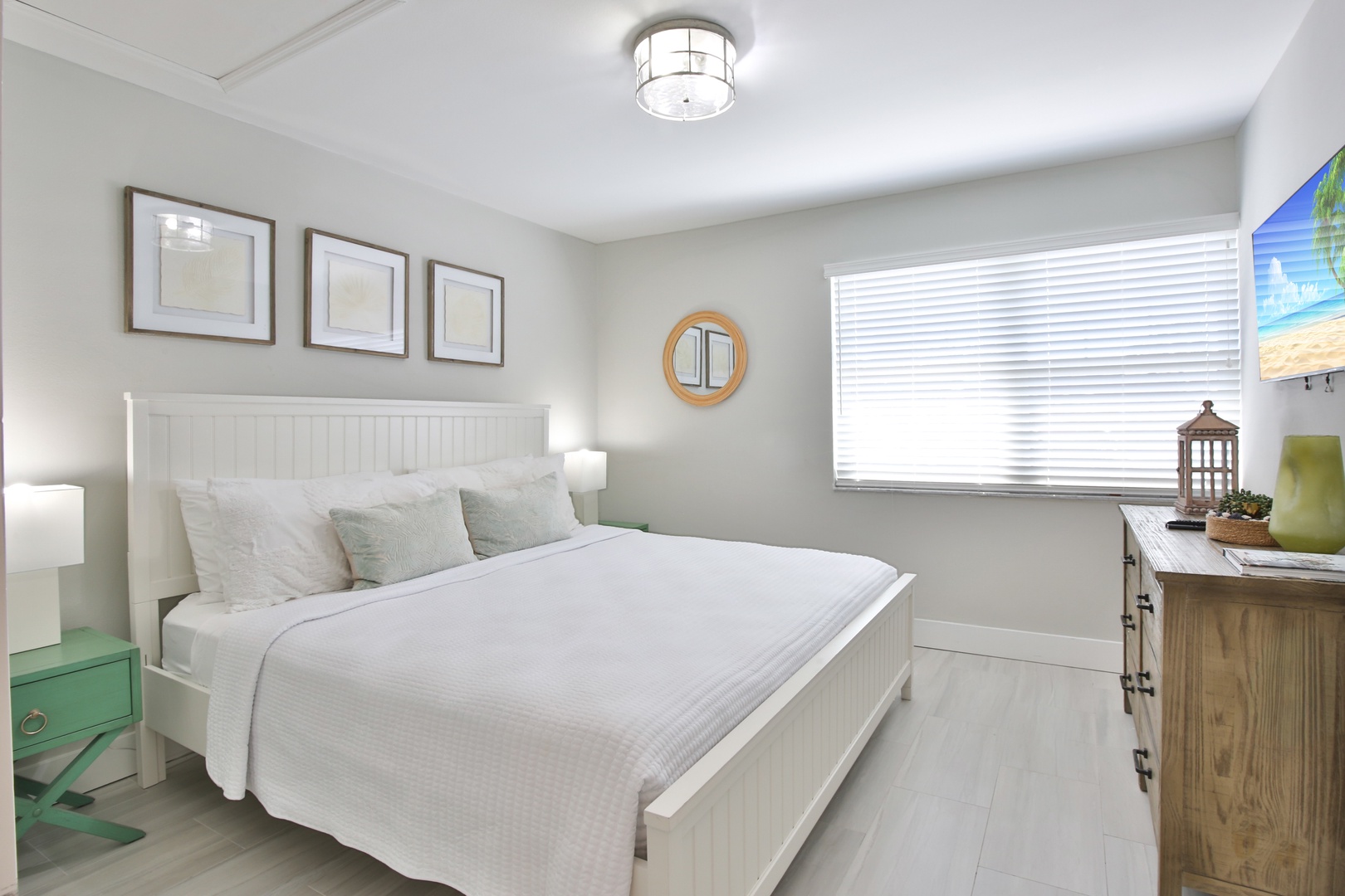 Sink into crisp white linens in your serene coastal bedroom, where nautical touches and gentle natural light create the perfect retreat.