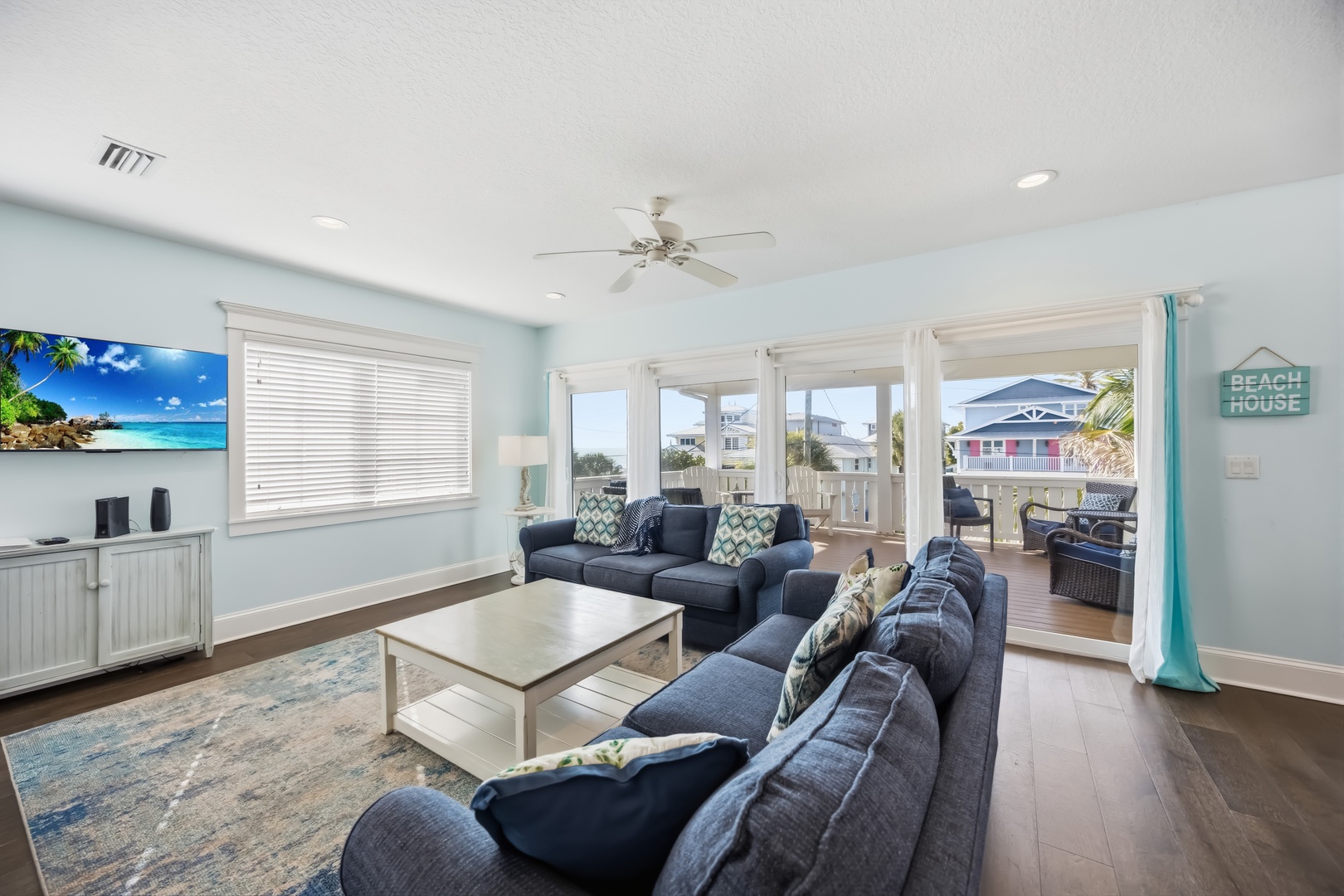 Unwind in your coastal living room where ocean breezes flow through open doors to your private balcony, perfect for morning coffee or sunset relaxation.