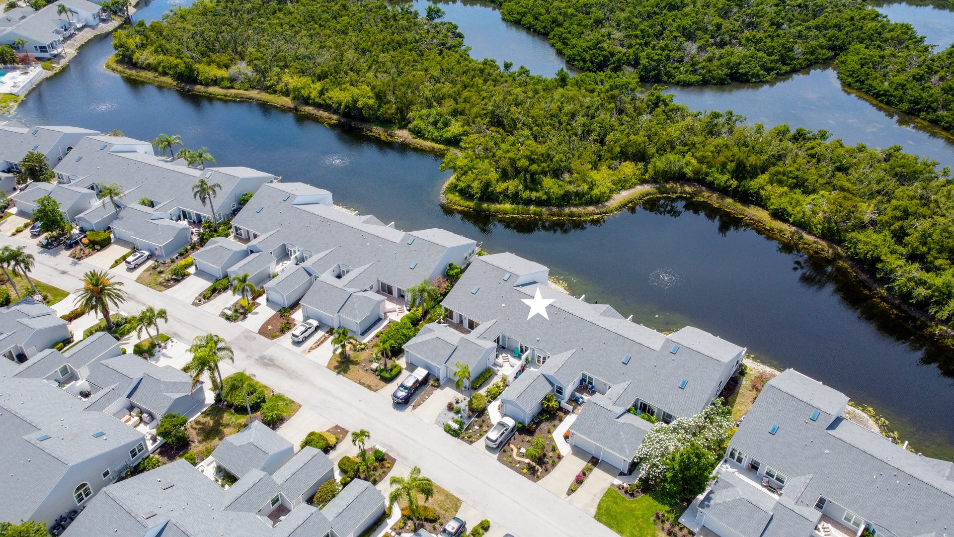 This waterfront property sits along a peaceful canal lined with lush mangroves, offering a private retreat adjacent to protected natural preserves.