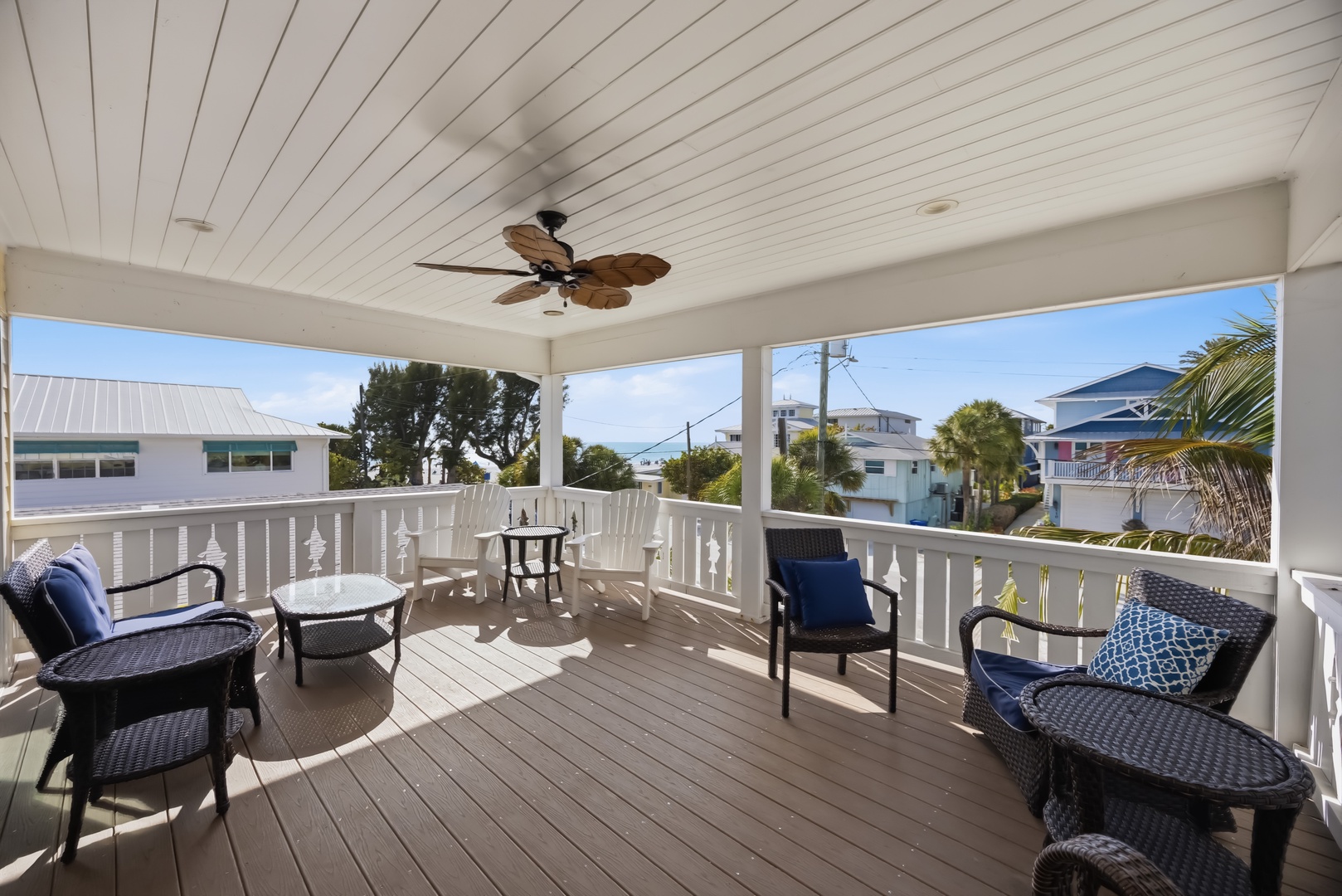Relax on your private covered deck with comfortable seating and tropical ceiling fan, overlooking the charming coastal neighborhood.