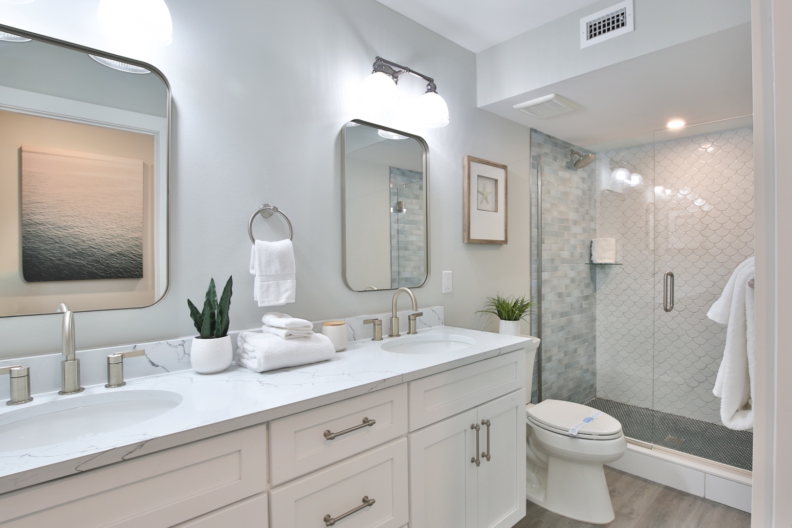 Step into your serene spa-like bathroom with double vanities, luxurious walk-in shower, and elegant finishes for ultimate relaxation.