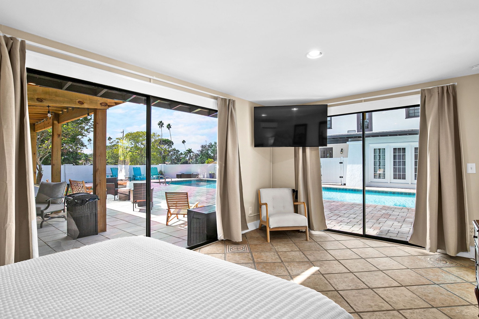 Wake up to stunning pool views through floor-to-ceiling windows in your private oasis, where indoor comfort meets outdoor paradise.