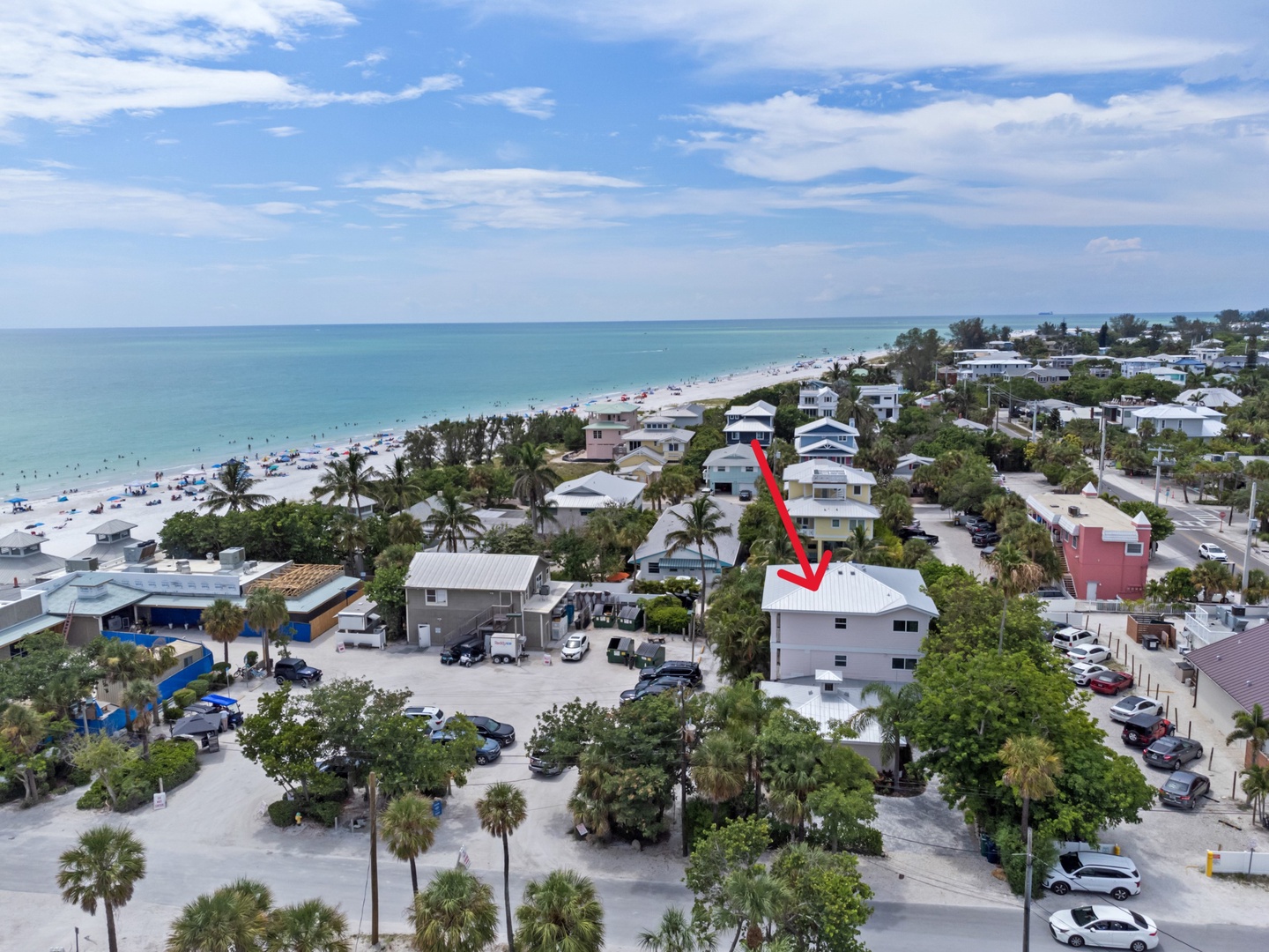 Aerial view of beachfront property location just steps from pristine white sand beach and turquoise waters.