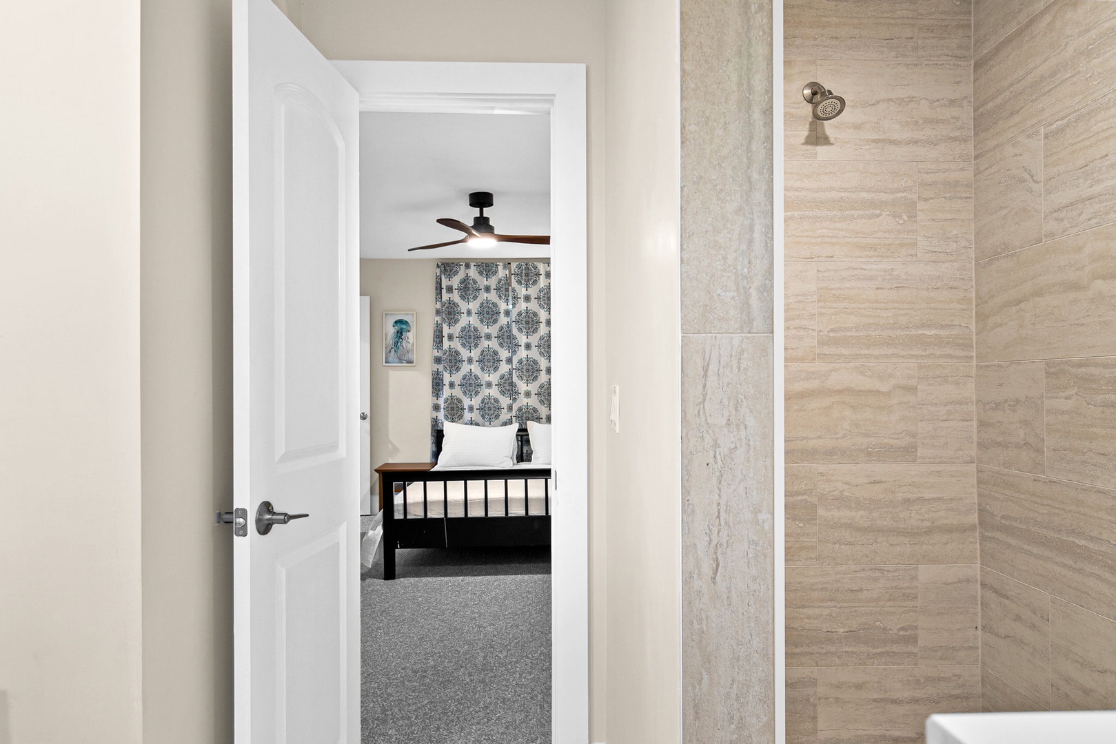 Step into your luxurious ensuite with stunning stone tile walls and rainfall shower, creating a spa-like retreat after exploring the city.