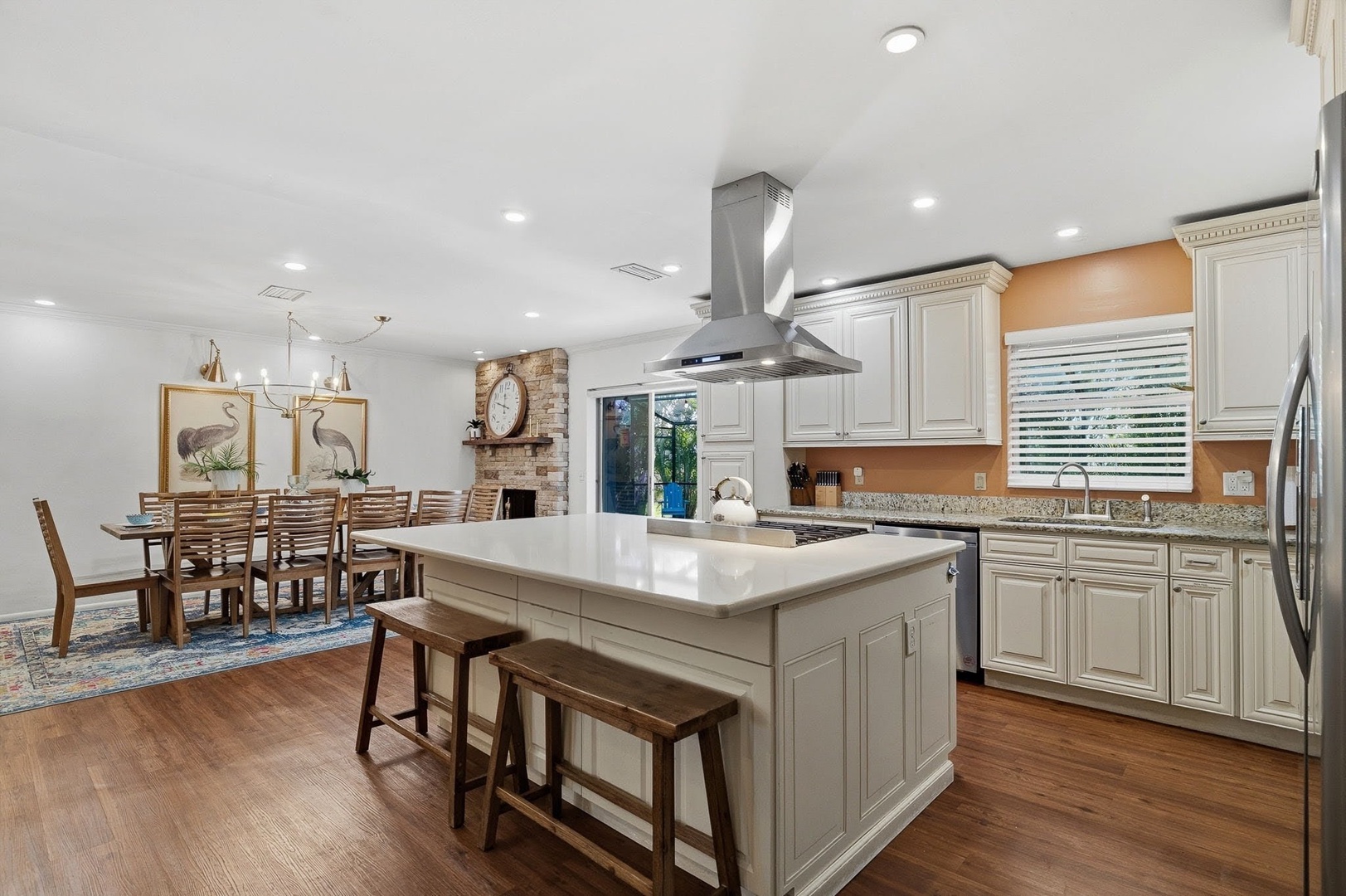Cook together in your spacious kitchen with granite counters, stainless appliances, and island seating before gathering for meals in the elegant dining area.
