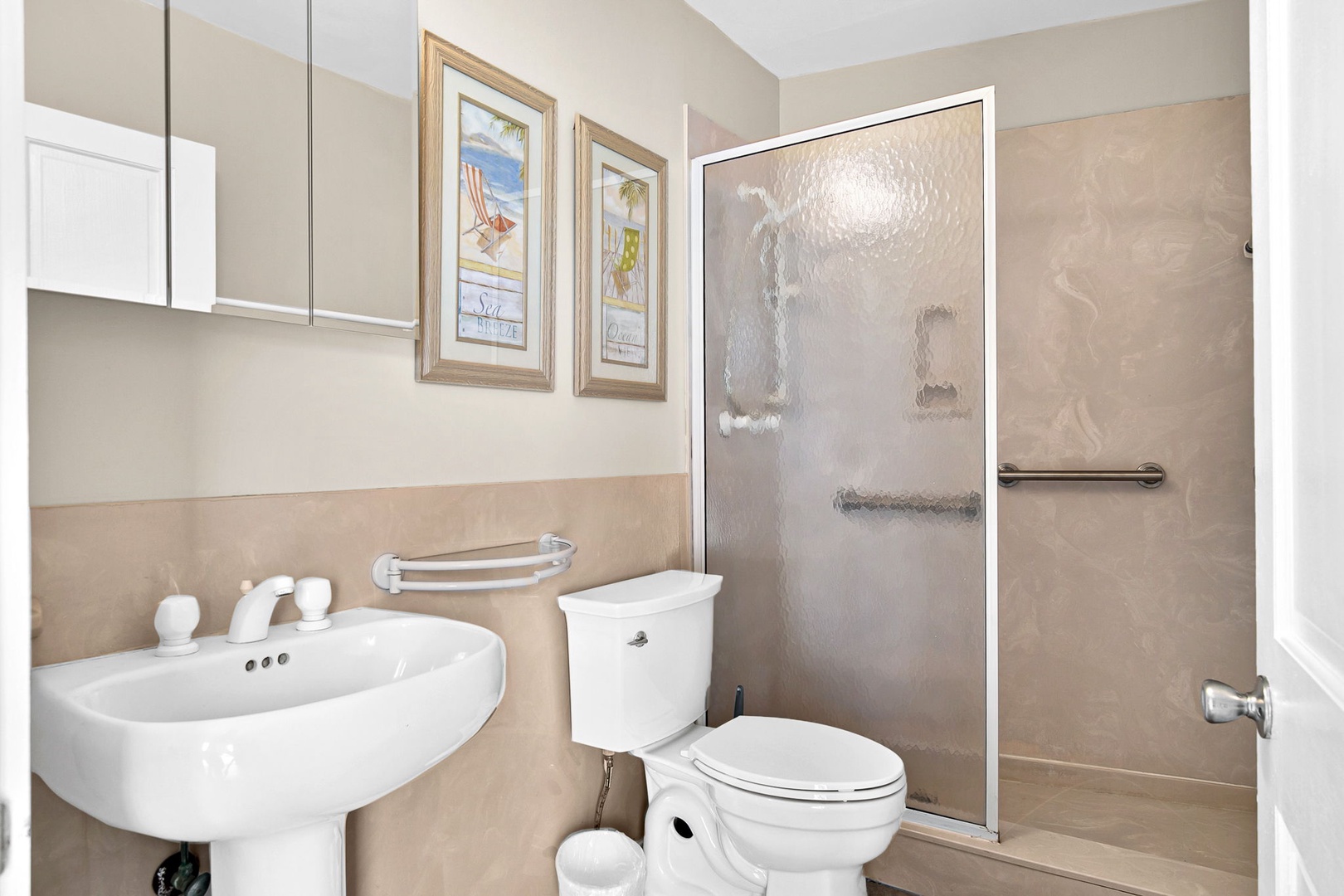 Your private bathroom features a walk-in shower with accessibility handles and everything you need to refresh after beach days.