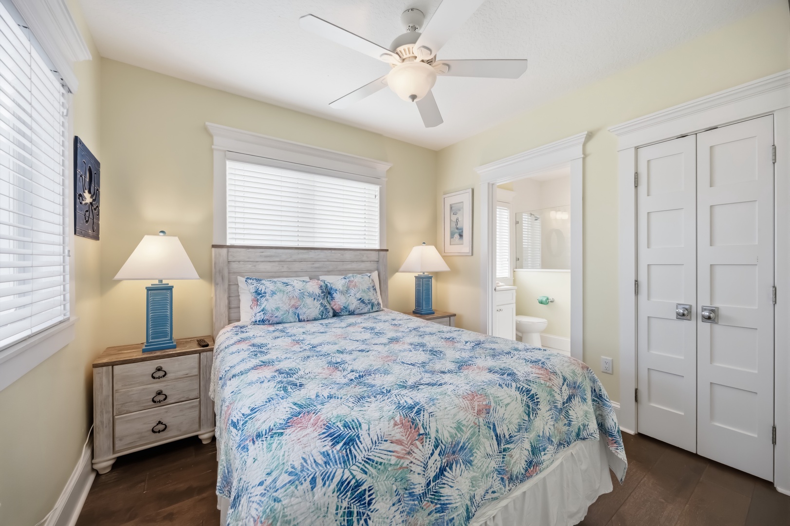Drift off in your peaceful bedroom featuring tropical bedding, gentle ceiling fan breezes, and charming coastal decor for the perfect seaside escape.