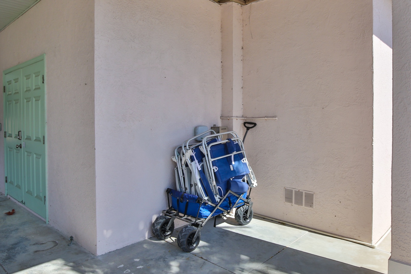 Beach chairs and cart await your sandy adventures, conveniently stored right outside your door for effortless beach days.