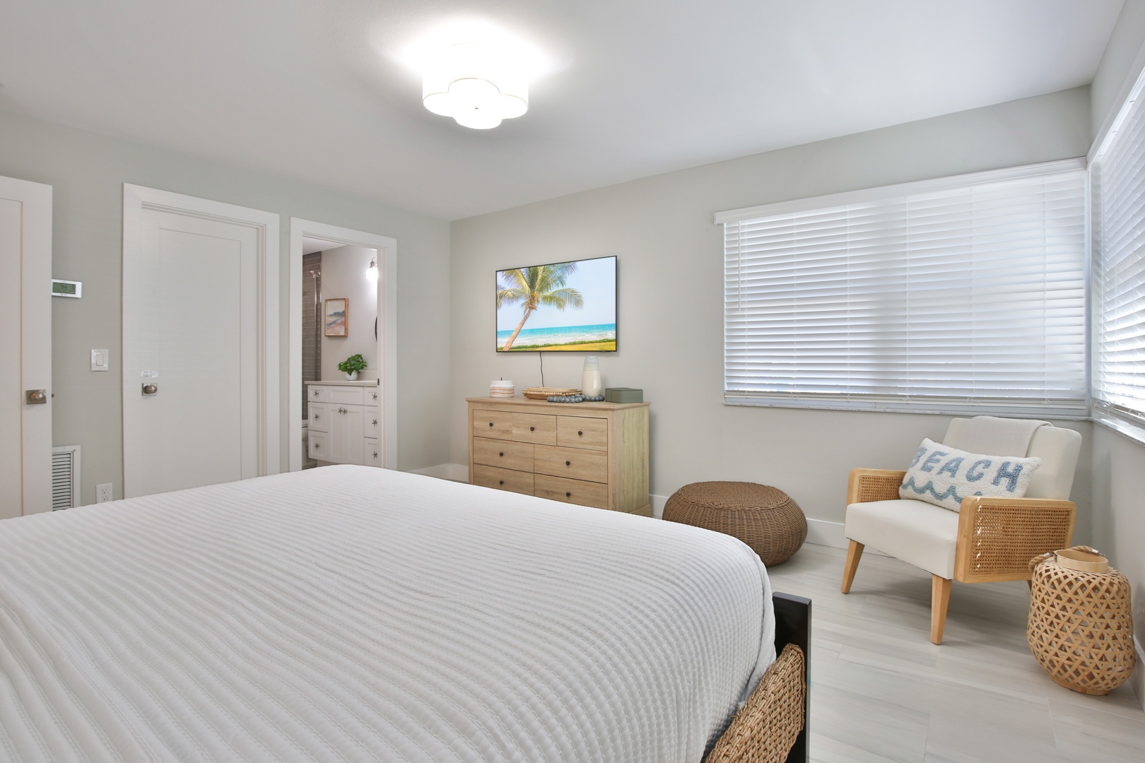 Drift off to sleep in your peaceful bedroom featuring crisp linens, natural textures, and coastal charm.