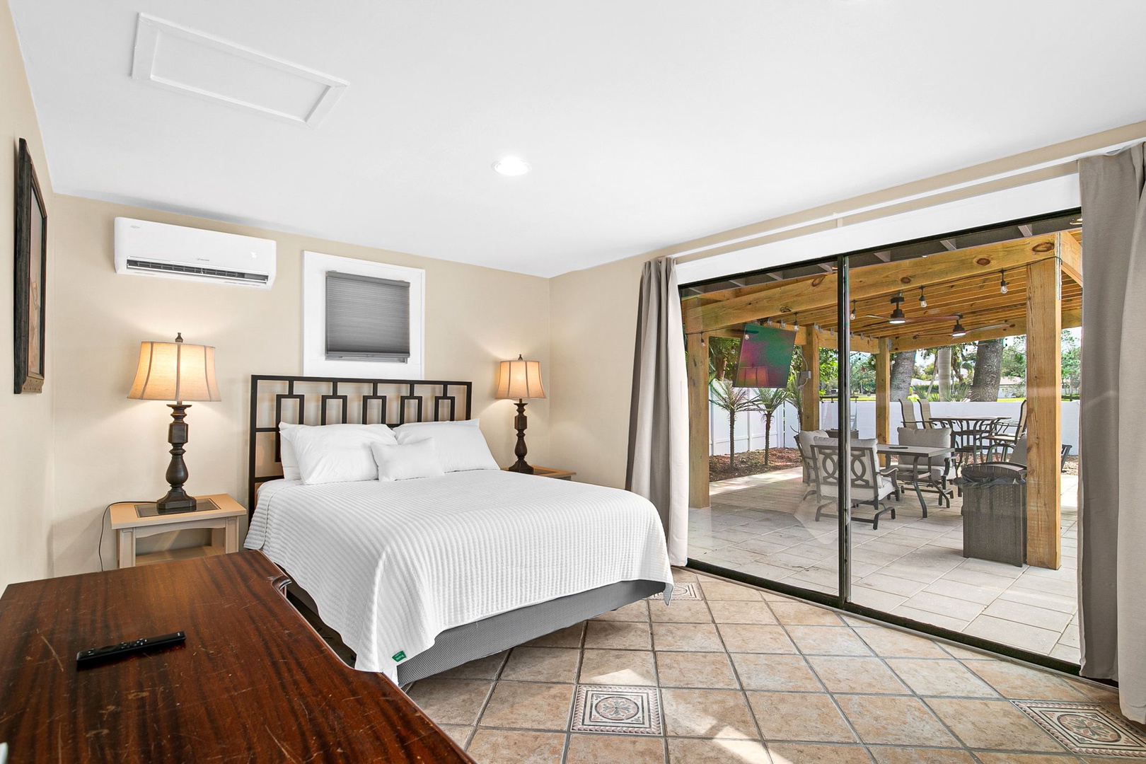Wake up in your elegant bedroom with seamless indoor-outdoor flow to your private patio oasis.