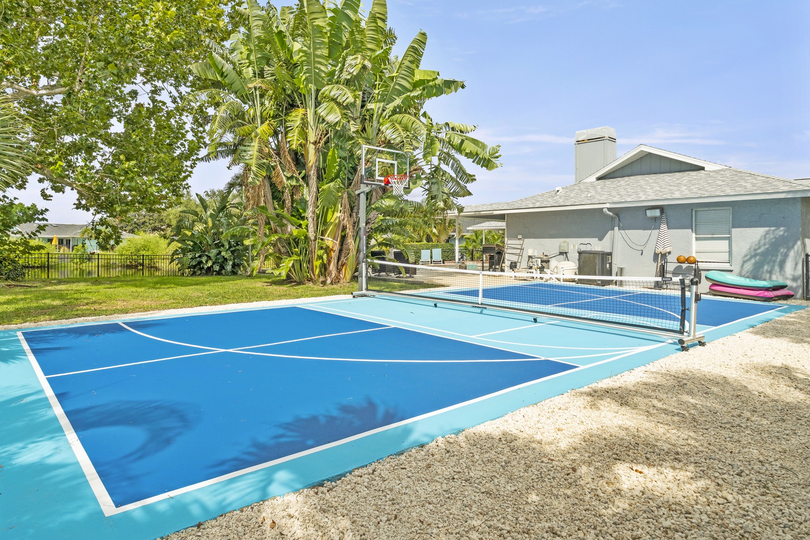 Challenge your travel companions to a friendly match on your private sport court, complete with basketball hoop and net for endless outdoor fun under sunny skies.