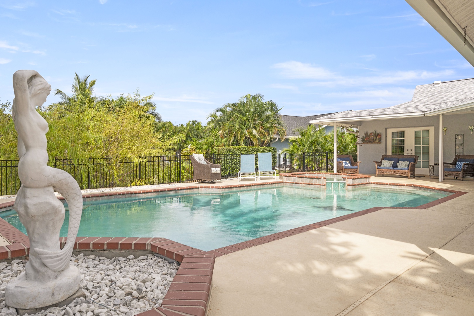 Picture yourself lounging poolside under warm sunshine, surrounded by lush tropical palms and serene garden views. Your private oasis awaits, with plenty of space to swim, sunbathe, and unwind in style.