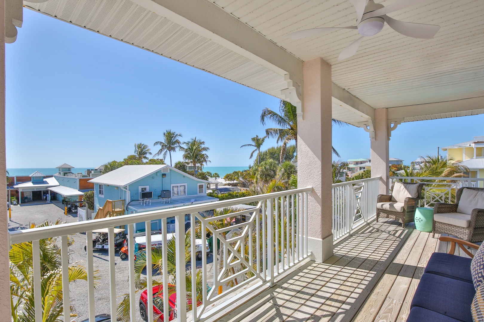 Relax on your private balcony with stunning sea views, tropical breezes, and comfortable seating overlooking the charming coastal neighborhood.