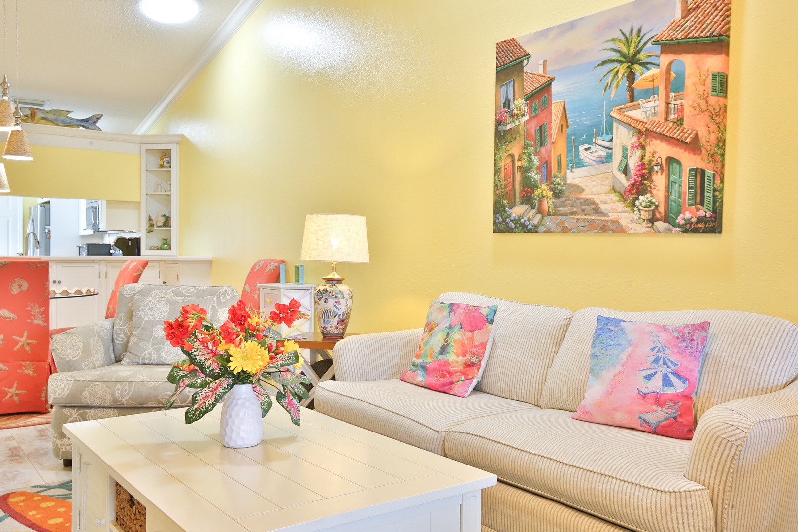 Sink into the soft sofa, enjoy vibrant accents and coastal art, and unwind in your cheerful, open-concept space with full kitchen access.