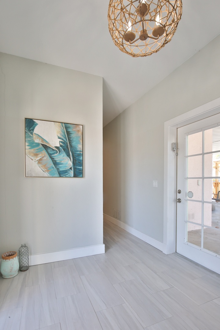 Step into your tranquil entry, where soft coastal artwork and warm pendant lighting create an instant sense of calm.