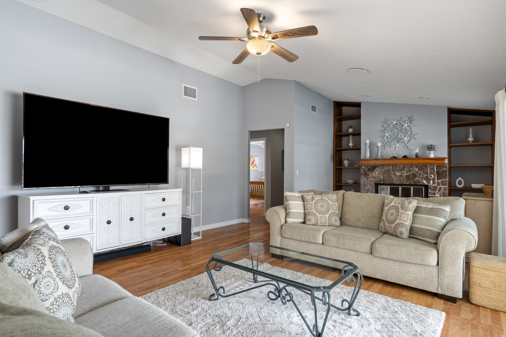 Unwind in your open-concept living space with comfortable seating, a cozy fireplace, and all the room you need to relax after exploring the area.