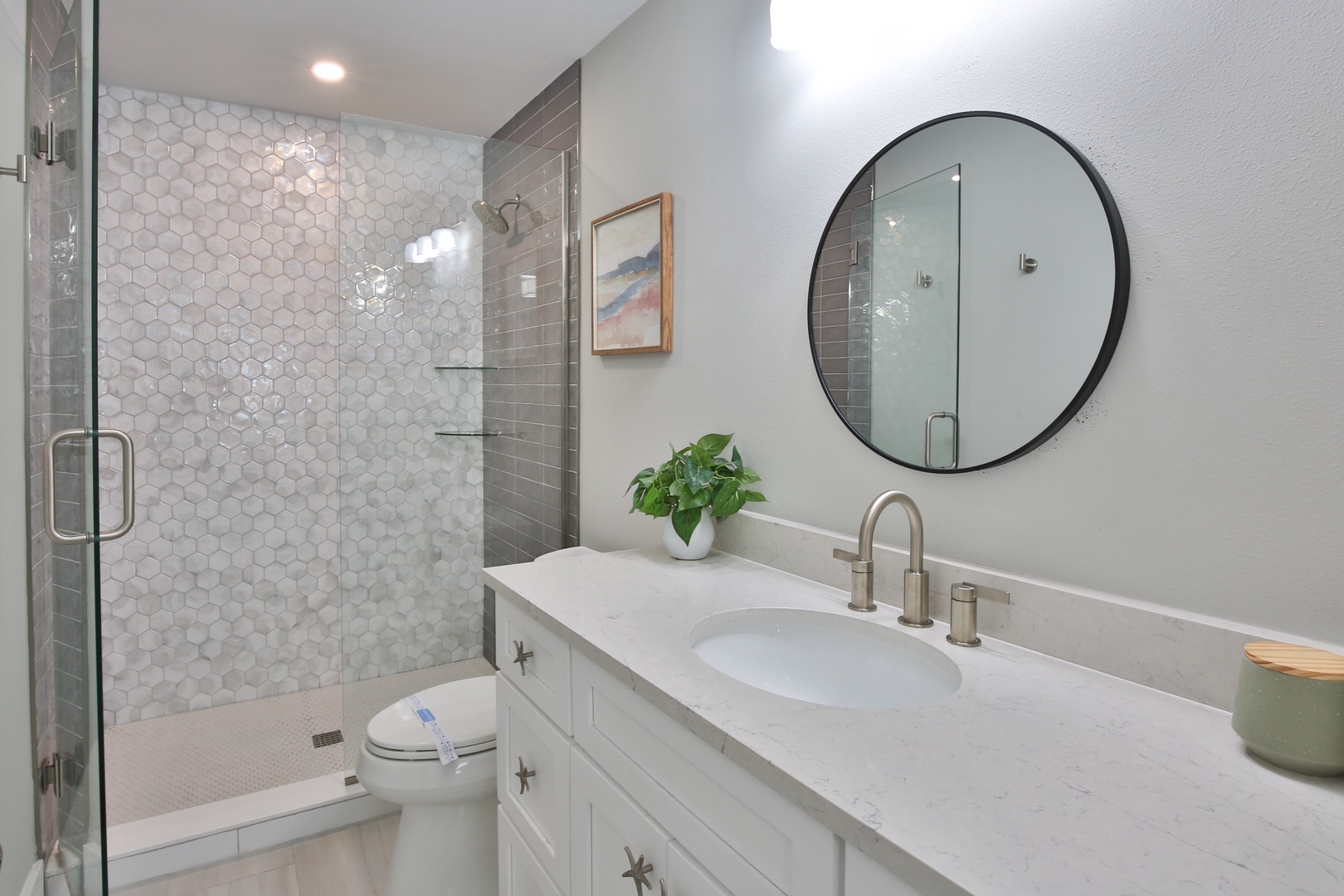 Step into your modern bathroom featuring beautiful honeycomb tile shower and elegant vanity for refreshing mornings.