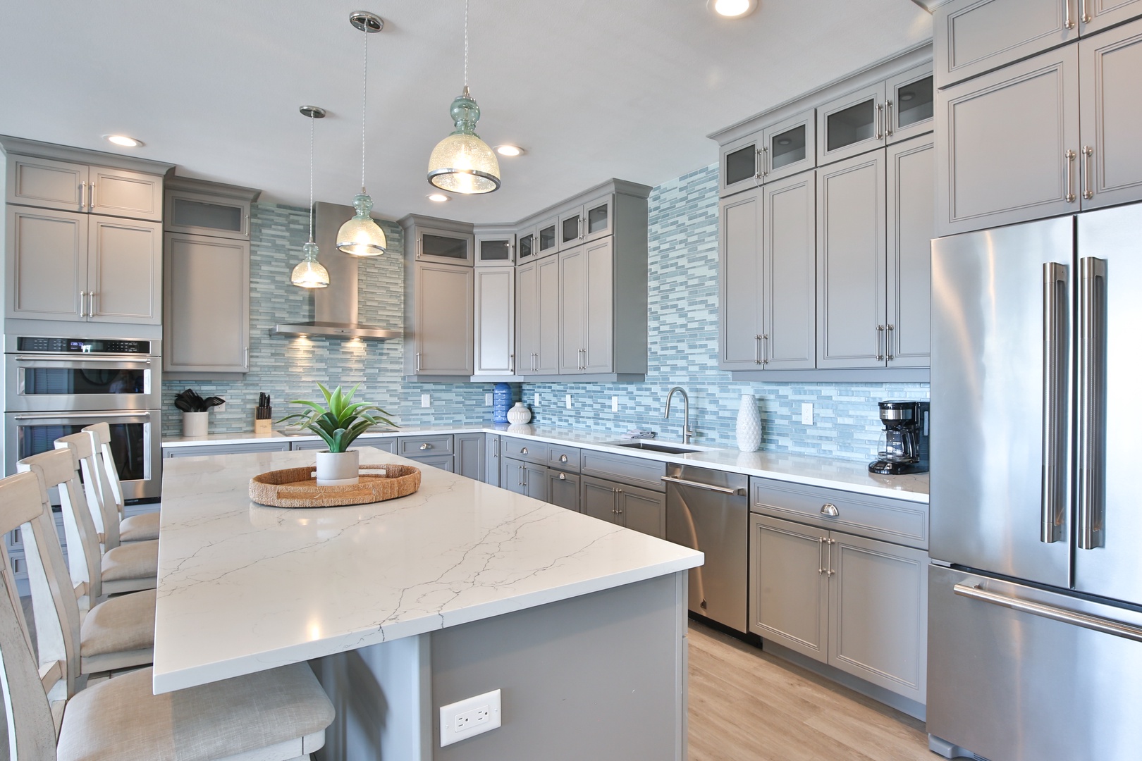 Step into your gourmet kitchen featuring granite countertops, stainless steel appliances, and elegant pendant lighting for memorable meal preparation.