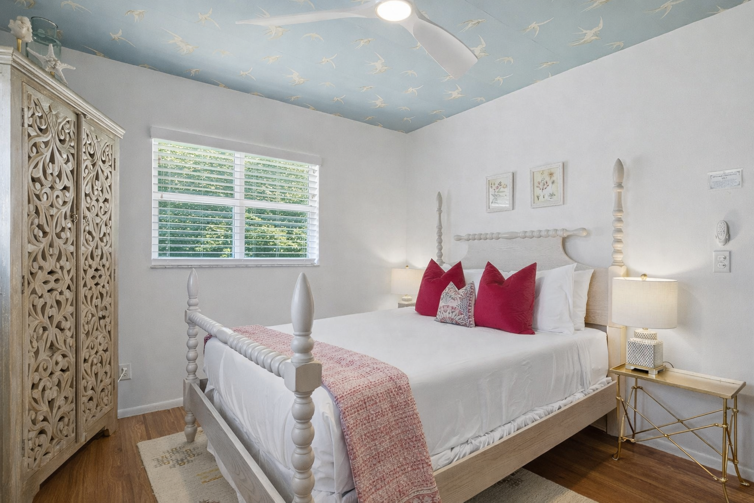 Drift off beneath starry skies in your dreamy coastal bedroom, where crisp white linens and coral accents create pure serenity.