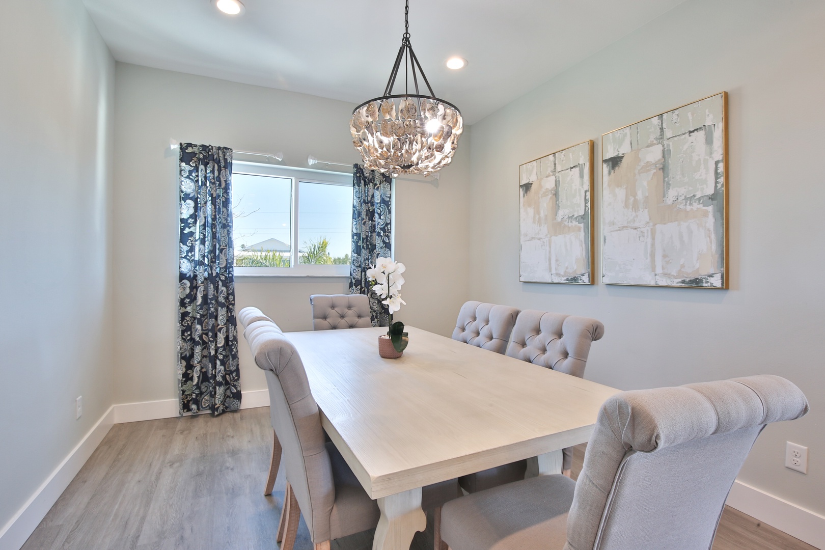 Gather around your elegant dining table under the stunning chandelier for memorable meals together.