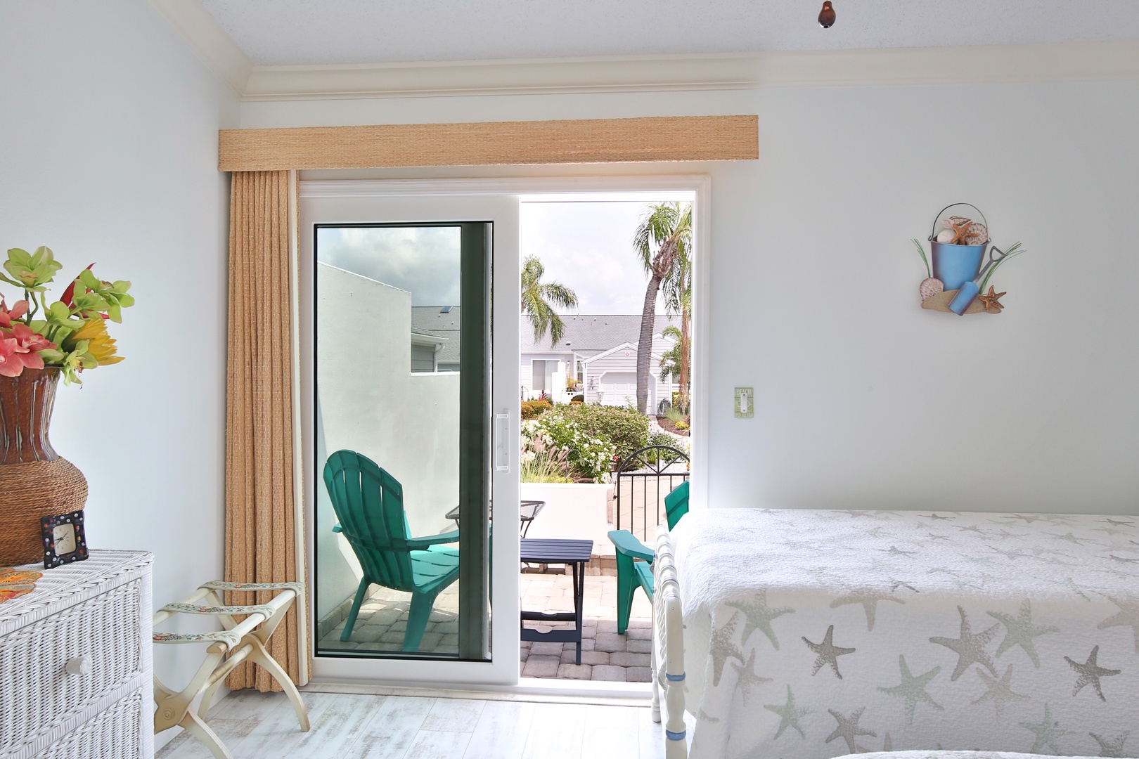 Relax in your coastal retreat with direct access to a peaceful patio and tropical surroundings, where breezy afternoons and starfish-adorned linens invite pure relaxation.
