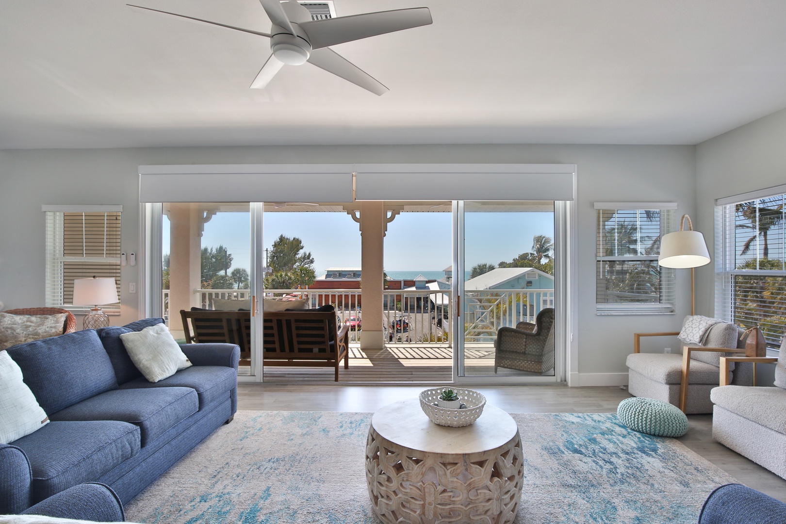 Relax in this bright coastal living space where ocean breezes flow through sliding doors to your private balcony with sea views.