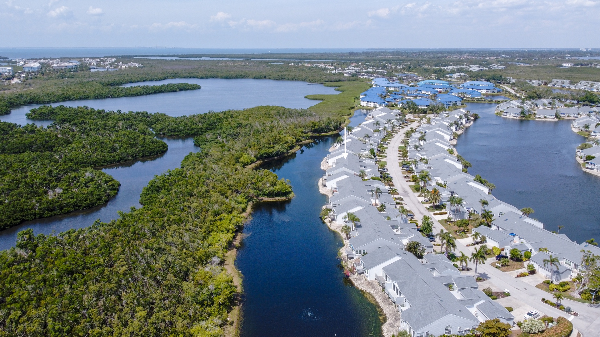 Stunning aerial view of this waterfront community nestled between serene lagoons and natural mangrove islands along Florida's coastline.