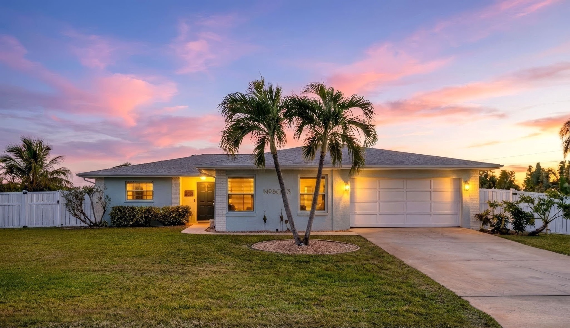 Tropical paradise awaits at this stunning property, framed by swaying palms and painted in sunset hues.