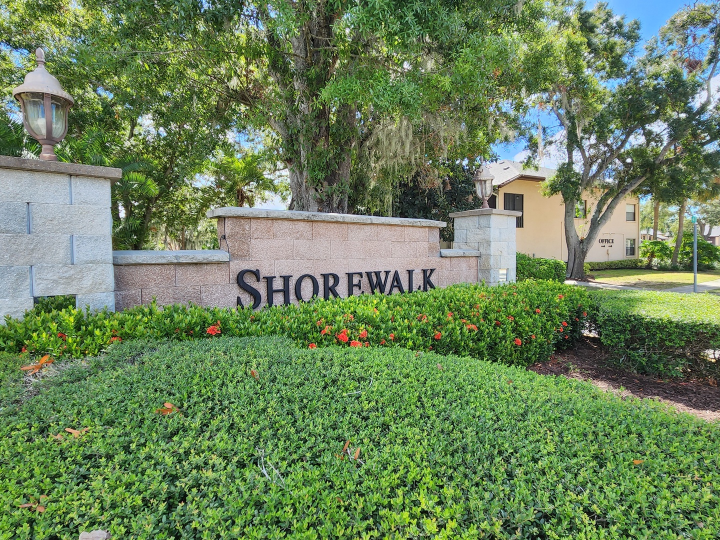 Welcome to Shorewalk! The elegant entrance sign greets visitors with professional landscaping and mature trees in this established community setting.