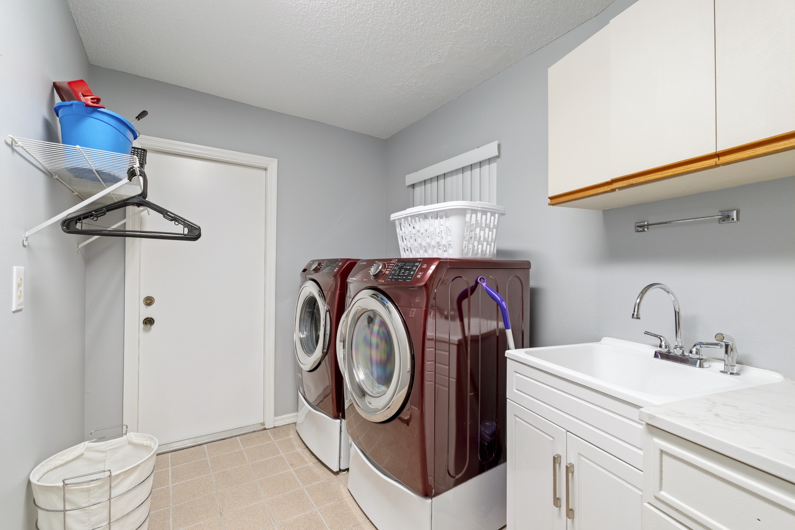 Your dedicated laundry room features a full washer and dryer, perfect for extended stays or beach days. Ample counter space and a convenient sink make it easy to keep everything fresh and ready for your next adventure.
