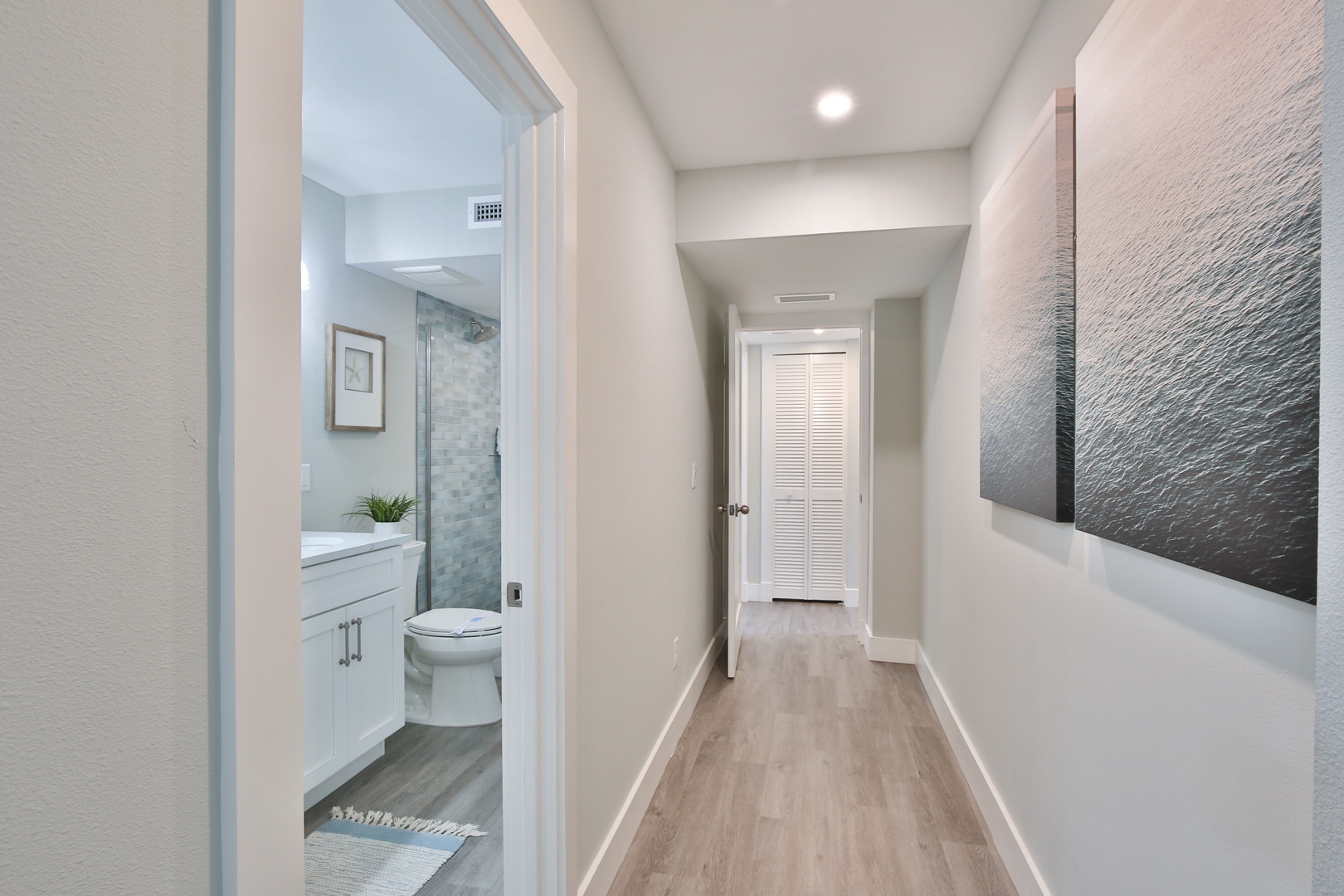 Step into your private hallway featuring clean lines, modern finishes, and easy access to your beautifully appointed bathroom.