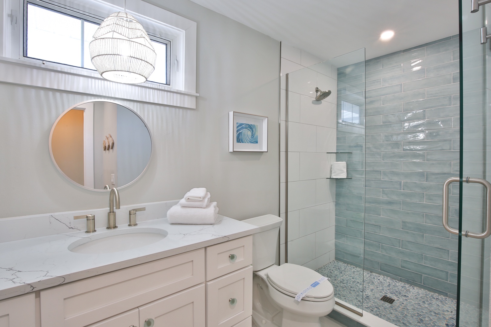 Step into your spa-like bathroom featuring a spacious glass shower and elegant marble vanity for ultimate relaxation.
