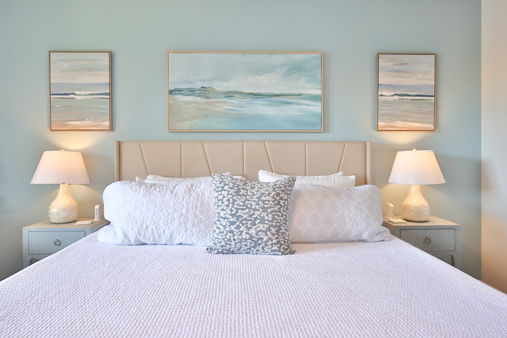 Sink into your tranquil coastal retreat with crisp linens and gentle ocean hues creating the perfect sanctuary for rest.