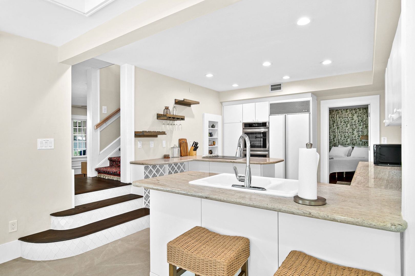 You'll love cooking in this bright, modern kitchen featuring sleek white cabinets, granite countertops, and an open layout that flows beautifully into the living spaces.