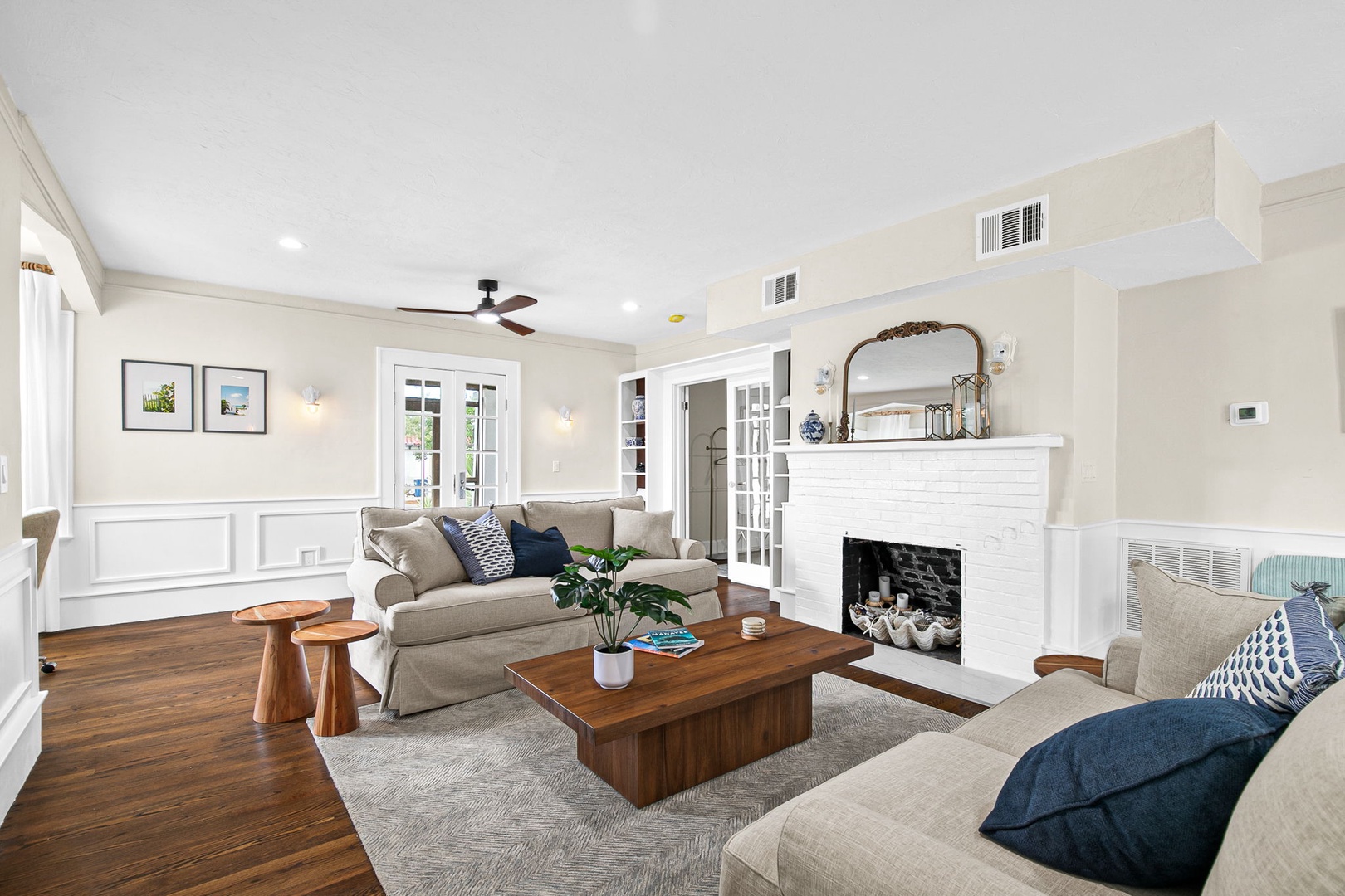 Sink into plush seating by your cozy fireplace, where elegant details and warm wood floors create the perfect retreat for relaxation.