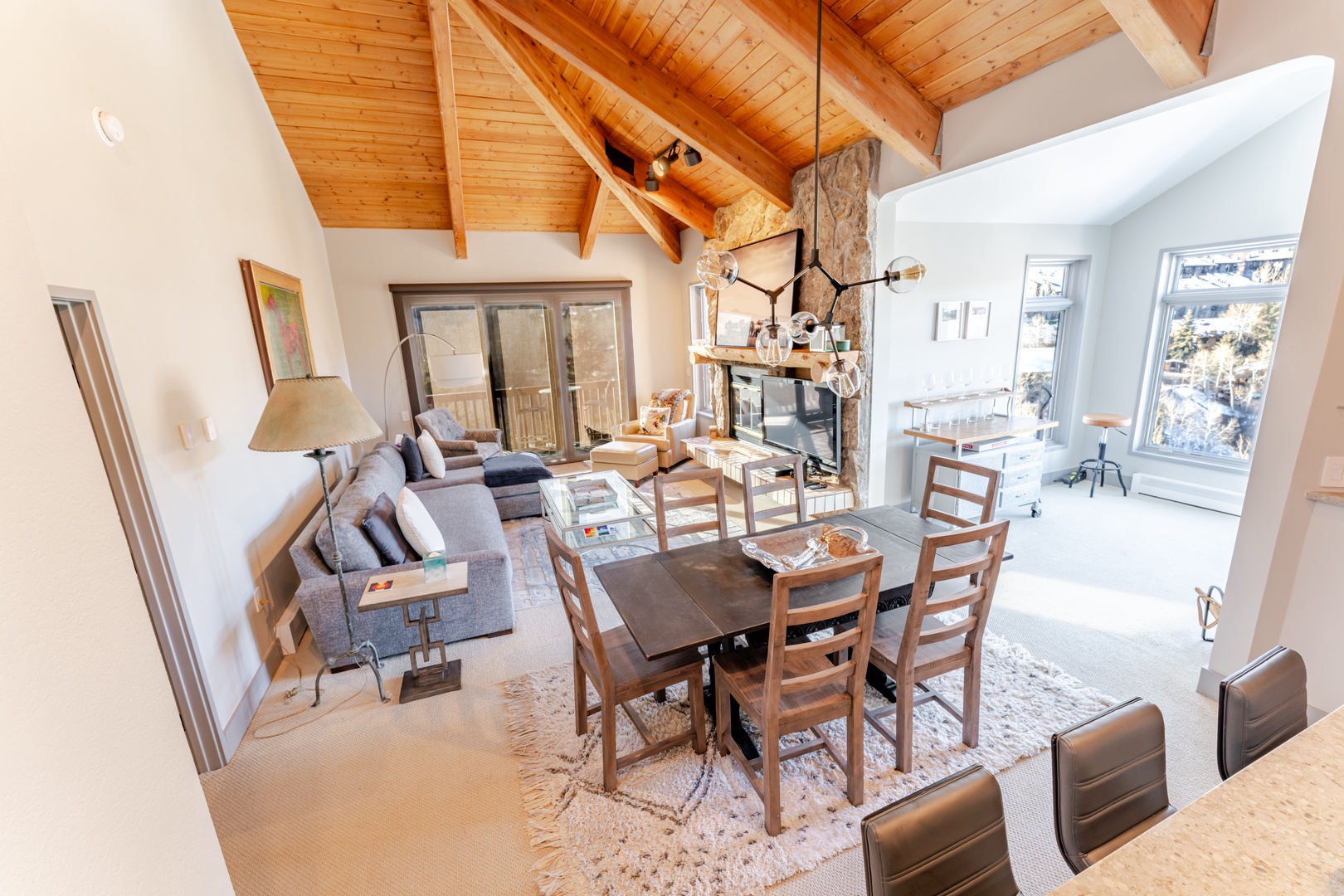 Relax in your spacious living area with stunning vaulted wood ceilings and cozy stone fireplace, perfect for memorable mountain getaways.