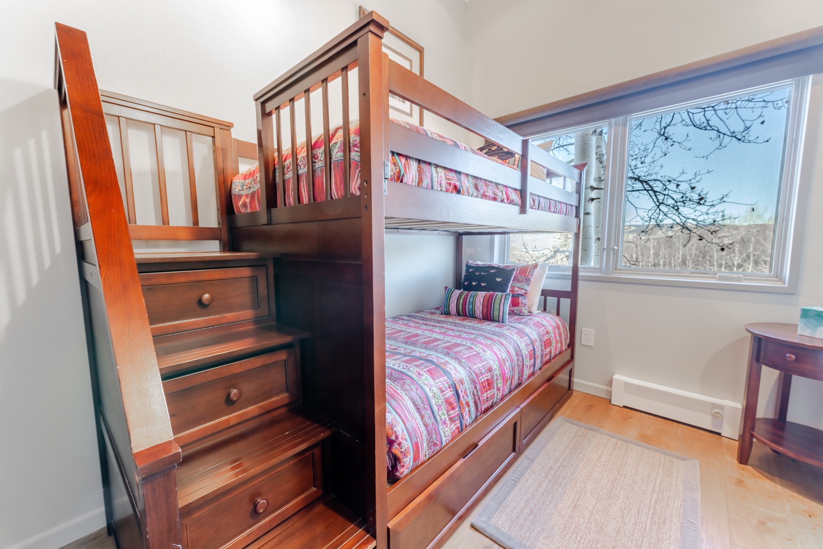Your kids will love this cozy bunk room with built-in stairs and storage, perfect for creating lasting vacation memories together.